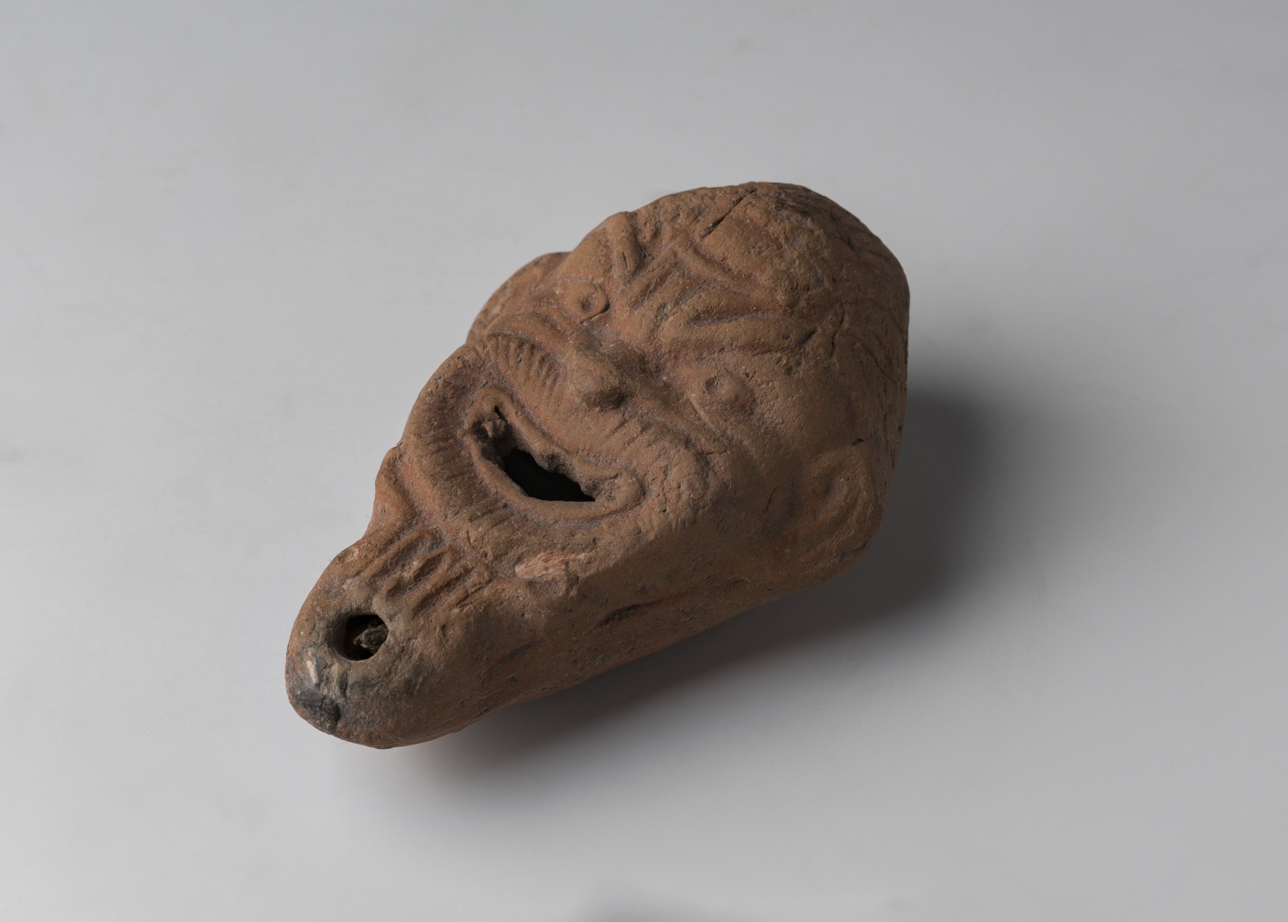 Lamp in the shape of the grotesque face of a Silenus
